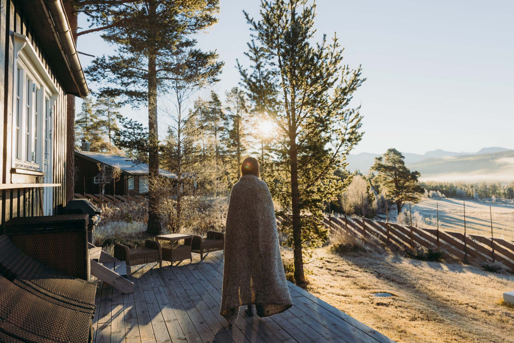 kvinne på terrassen på hytta